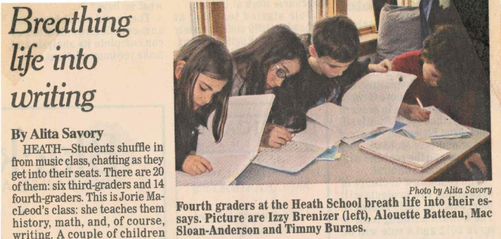 Young students writing in notebooks